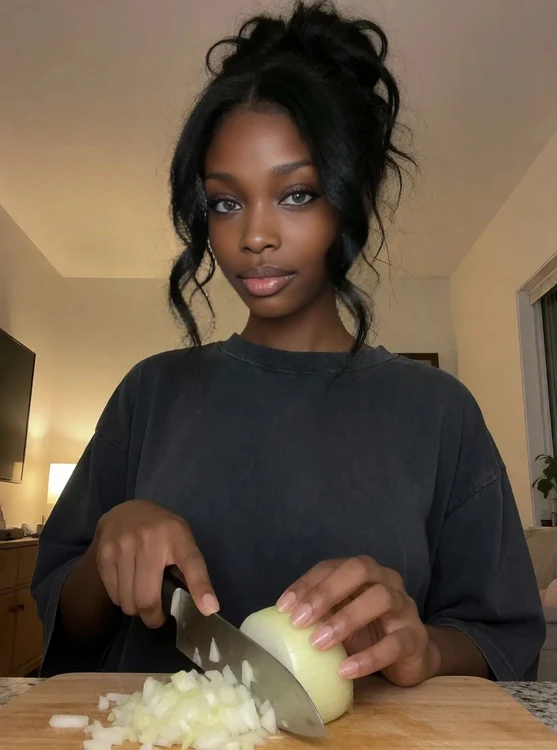 Rhea - Chopping onions, oversized tee, messy bun; over-the-shoulder shot, evening light